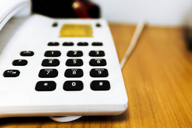 istock vintage push-button white phone with black buttons on the table, blur 1306851938