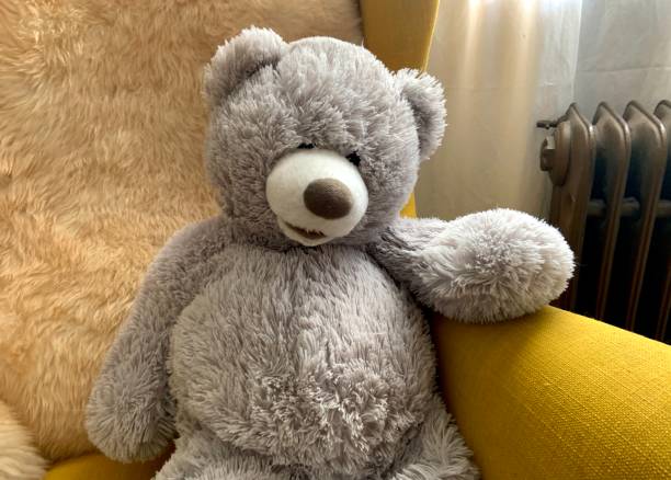 istock Gray Teddy Bear sitting on Chair 1306854394