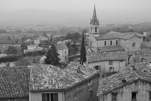 Rooftops and church in the Provençal hilltop village of Bonnieux in black and white