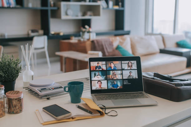 laptop with screen video conference on kitchen counter with smart phone , note pad laptop with screen video conference on kitchen counter with smart phone , note pad web conference stock pictures, royalty-free photos & images