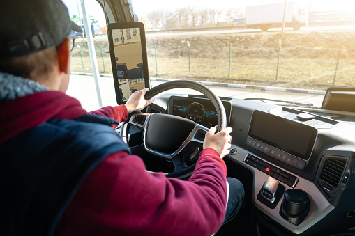 Man driving a truck with rear view camera