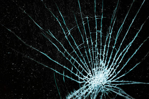 istock Shattered glass window against a black background 1306858449