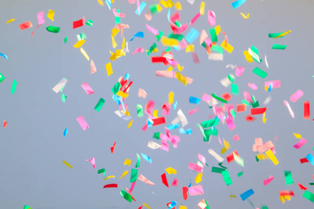 istock multicolored confetti on a grey background. Concept of holiday b 1306861369