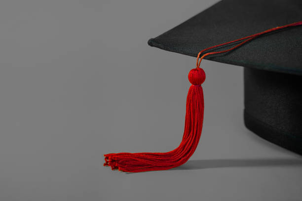 istock A mortarboard on isolated gray background with empty copy space to the left. Stock photo 1306861977