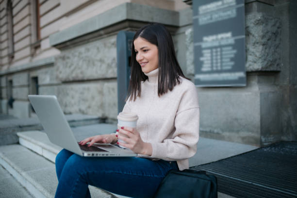 istock Happy young Caucasian female student using a laptop 1306864576