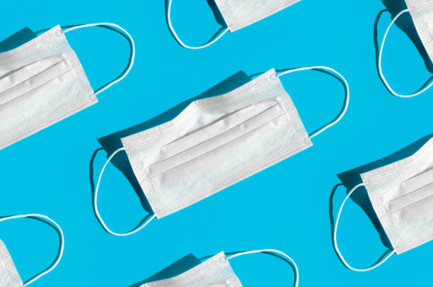 istock Medical or surgical face mask on a bright blue background. 1306866863