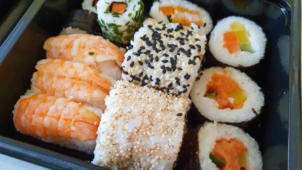 istock Different types of sushi on a black tray 1306868072