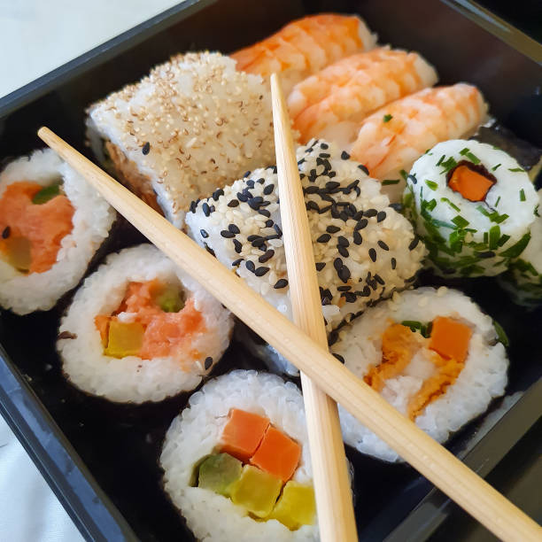 istock Different types of sushi on a black tray 1306868090