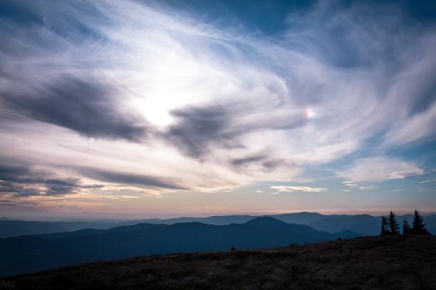 Halo natural phenomenon through clouds. Mountain Landscape view in windy weather. stock photo