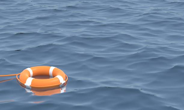 istock Orange life buoy in the ocean. 1306871985