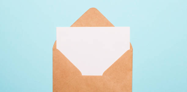 istock On a light blue background, an sheet of paper with a place to insert text in a craft envelope. Copy space 1306872009