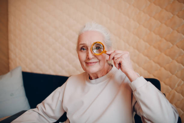 istock The elderly woman with magnifier loupe in hand 1306872899