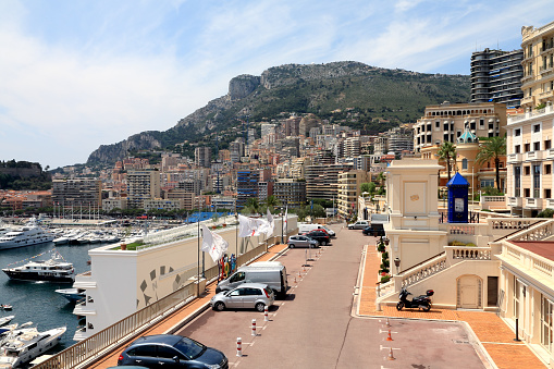 Monte-Carlo, Monaco - June 06, 2009: Dense urban development is separated from the large marina by a city street. In the background there are hills. It is one of the countless wonderful places that is a tourist attraction often visited by many tourists from all over the world.