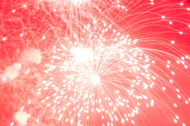 istock Fireworks. Bright, red flashes of fireworks in the dark sky. 1306874141