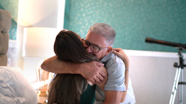 istock Father embracing daughter at home 1306876627