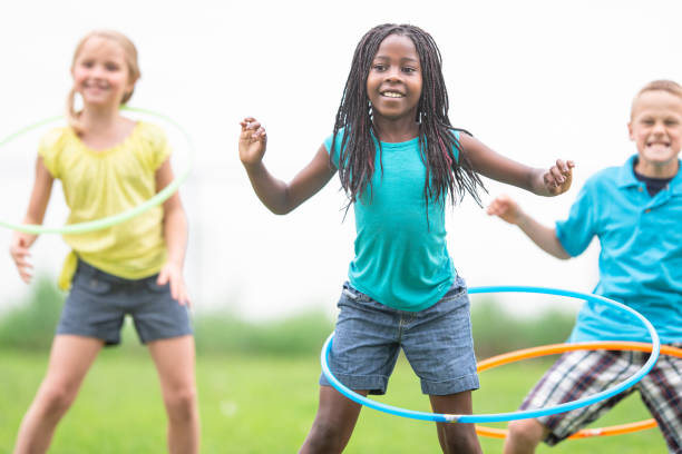 istock Children Hula Hooping At The Park 1306879291