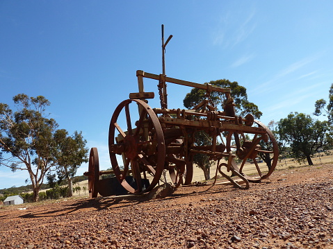 An old piece of farm equipment sits on drought ravaged farmland in the outback of Western Australia.