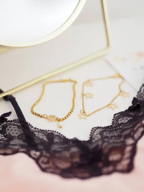 Gold bracelets, babydoll dress and mirror