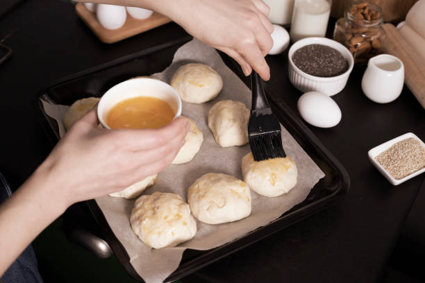 istock yeast dough ready for making homemade buns is on the table among other ingredients for baking bread. a woman prepares pastries, sifts flour. 1306880578