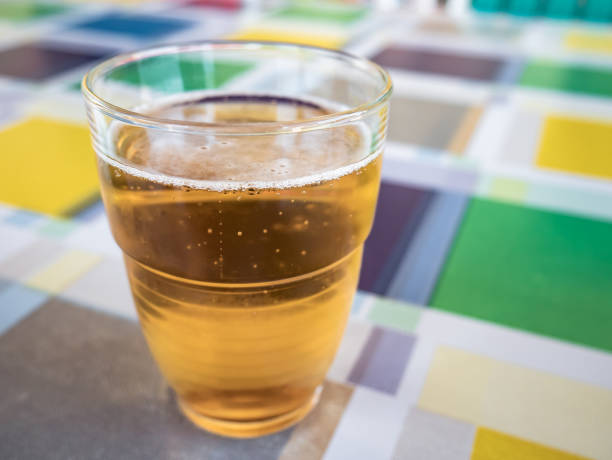 istock glass with beer inside on a table with colored squares oilcloth 1306881504