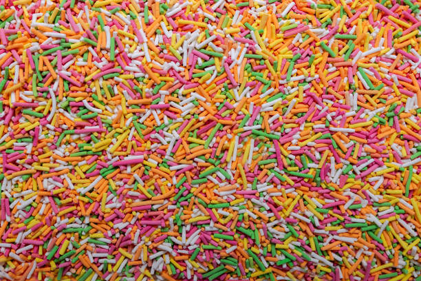 istock Background and texture from colorful cake decorations.  Colorful sprinkles background, decoration for cake and bakery. 1306883471