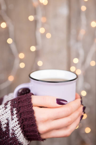 istock Woman in cozy sweater holding a cup 1306883636