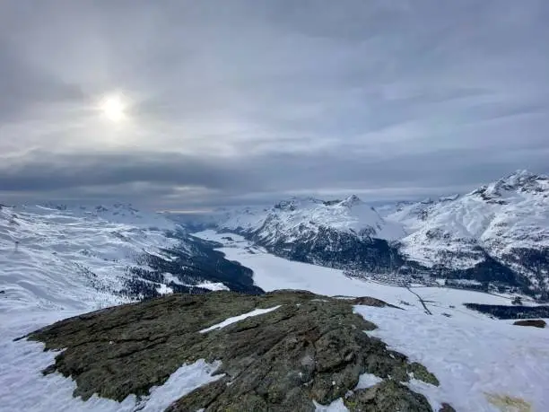 View of valley and frozen lakes and towns  Silvaplana-Surlej and Sils-Maria from Giand’ Alva viewing point at Skiarea Corvatsch/Furtschellas, Engadine, Switzerland