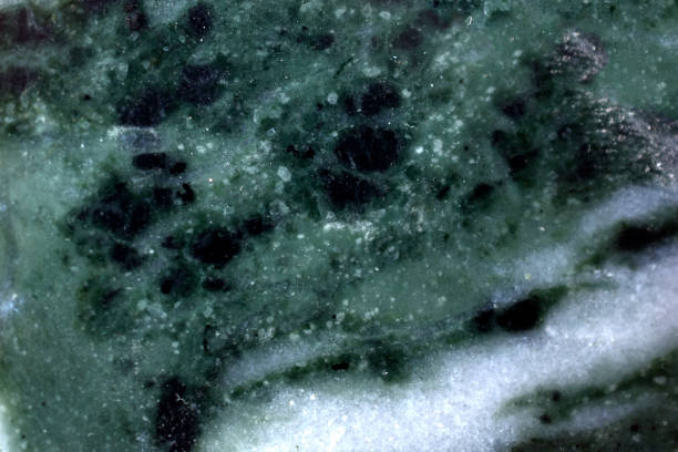 istock Green surface of granite and marble with streaks and cracks 1306888048