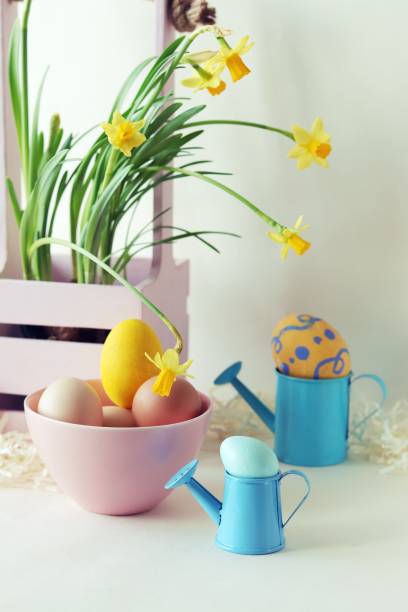 istock Easter decorations, eggs and a bouquet of spring yellow flowers on a light background 1306888214
