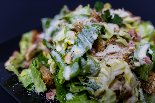 Caesar salad with lettuce, croutons, chicken breasts and spices