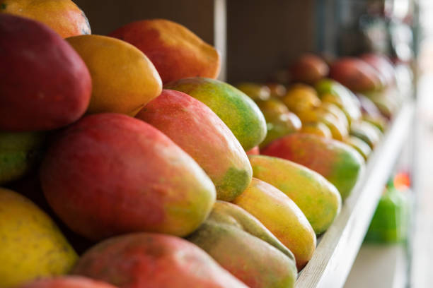 fruits on supermarket counter all with good presentation and green and yellow color.\nPeach on supermarket counter
