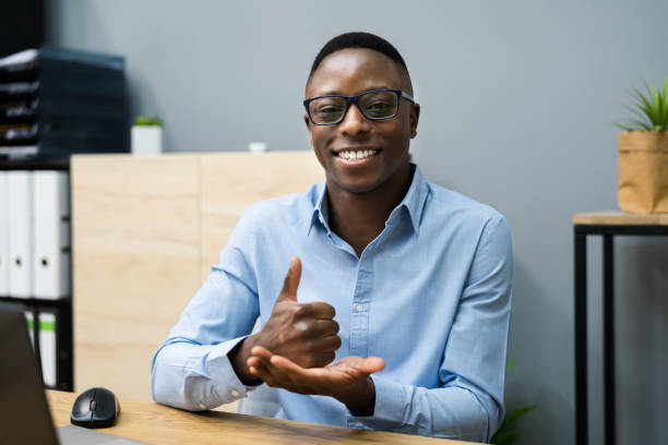 African American Man Learning Sign Language Young African American Man Learning Sign Language deafness photos stock pictures, royalty-free photos & images