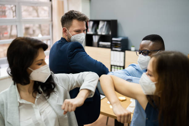 istock Business People Elbow Bump Wearing Face Mask 1306891064