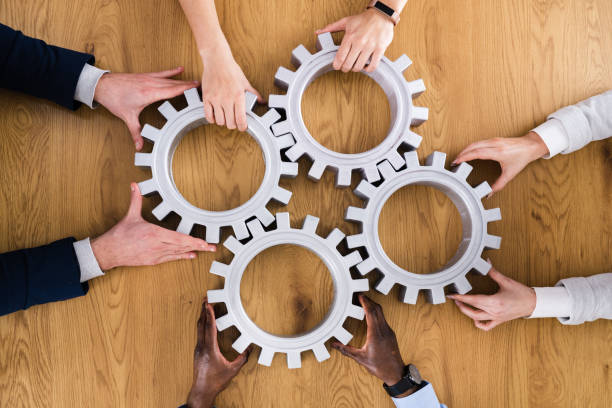 istock Businesspeople Hands Joining Gears. Support 1306891500