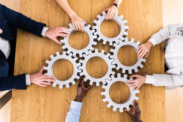 istock Businesspeople Hands Joining Gears. Support 1306891510
