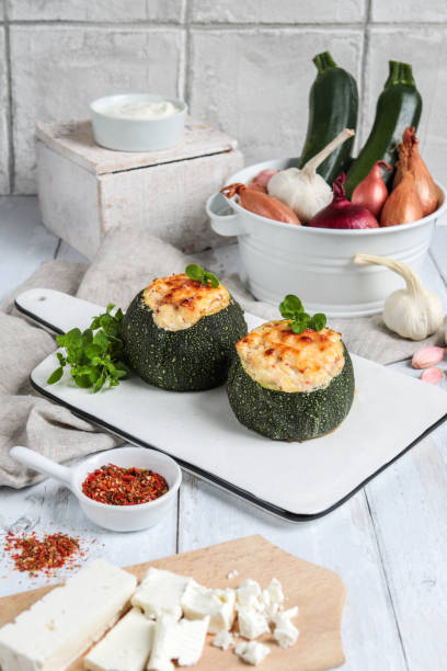 Baked stuffed zucchini garnished with sliced ​​grilled tomatoes. Fresh from the oven, served with fresh baguette and a glass of white wine. A meal for connoisseurs.
