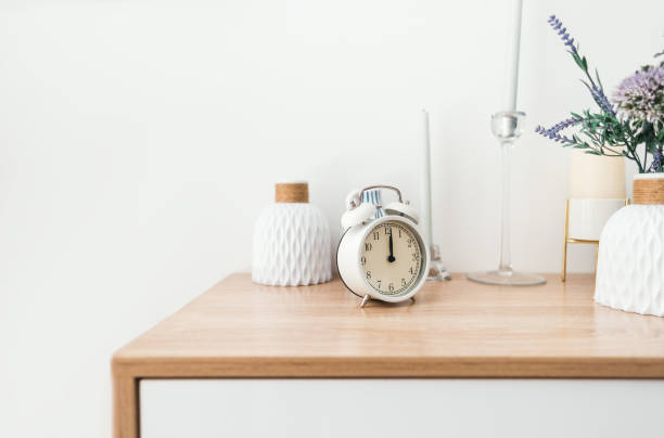 White alarm clock on wooden table with copy space... stock photo