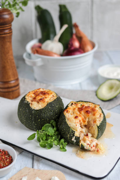 Stuffed Zucchini with Feta cheese and mediterranean Herbs Stuffed Zucchini oven baked with Feta cheese and mediterranean Herbs vibrant color lifestyles vertical close up stock pictures, royalty-free photos & images