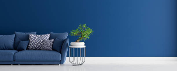 istock Mock up Living room interior design with blue sofa, empty blue wall with free space on right 3D render 1306894656