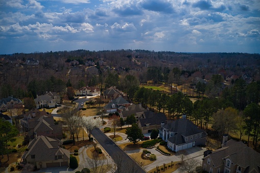 Atlanta, GA- March 13,2021: A aerial view of house cluster in an upscale sub division in suburbs of Atlanta with a a golf course and a lake