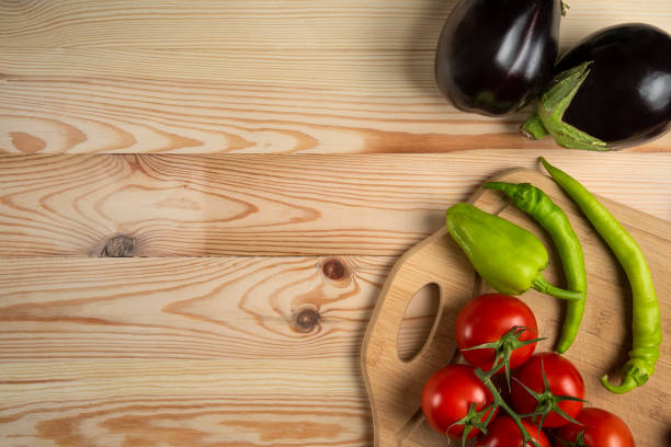 istock Green chilies and tomatoes on the wooden table 1306895849
