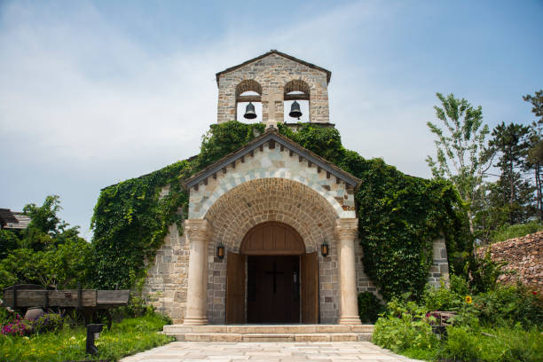 istock Medieval church building with two ringing bells on the top 1306895903