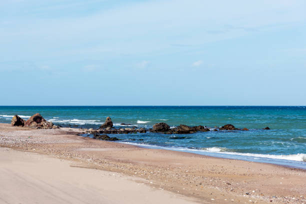 istock Rocks with sea and sand view on the beach 1306898954