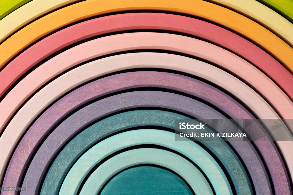 Wooden rainbow stacker toy Colorful, arched building blocks. Pastel colored wooden rainbow stacker toy. Toy Block Stock Photo