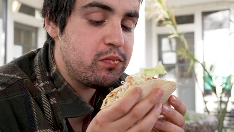 Young man having a taco