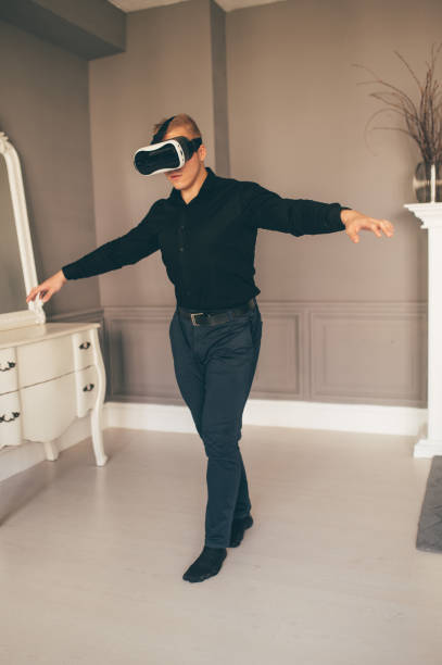 istock Young brutal man Using VR In The Living Room 1306904685