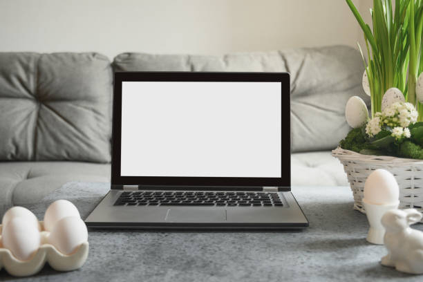 Laptop in home spring interior with Easter decoration.