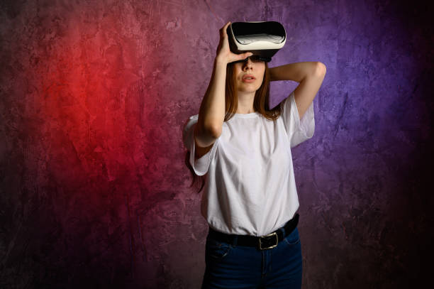 istock Happy young woman using a virtual reality headset 1306905756
