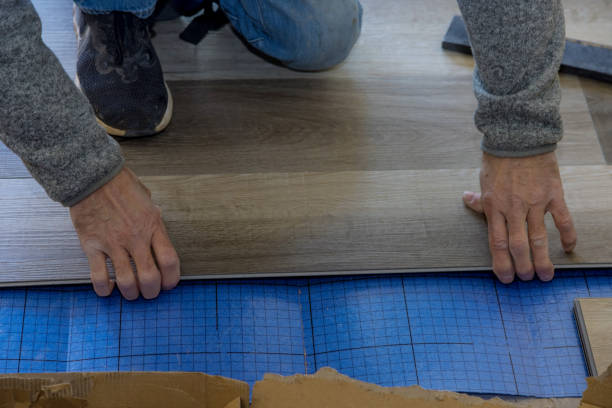 istock Installing laminate flooring in the apartment 1306906653