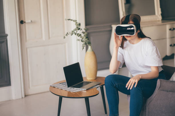 istock Young female programmer testing a new app with virtual reality glasses in home 1306906671